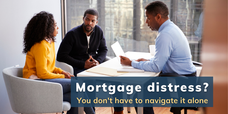 Mortgage Distress? You don't have to navigate it alone. Pictured: Couple in an office with a financial officer, looking distressed over mortgage issues.